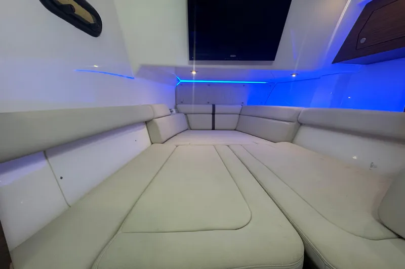  Yacht Photos Pics 2022 Boston Whaler 350 Realm interior cabin with blue LED lighting and cushioned seating.