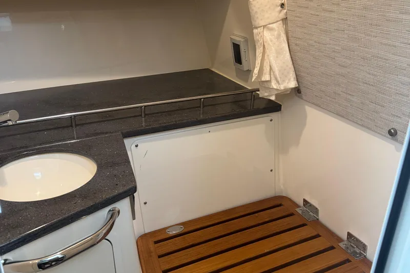  Yacht Photos Pics 2022 Boston Whaler 350 Realm interior with sink and wooden flooring.