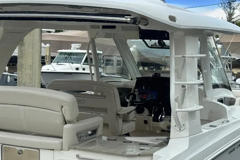  Yacht Photos Pics 2022 Boston Whaler 350 Realm boat interior with helm and seating area.