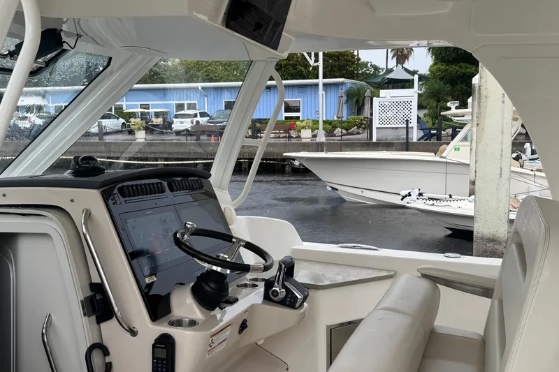  Yacht Photos Pics Interior view of 2022 Boston Whaler 350 Realm boat at marina dock.
