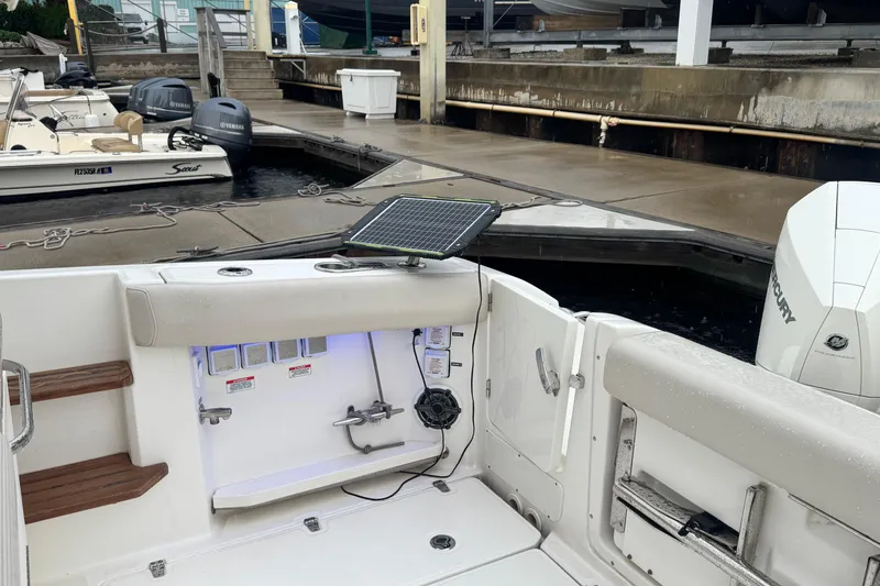  Yacht Photos Pics 2022 Boston Whaler 350 Realm boat interior with docked view and solar panel setup.