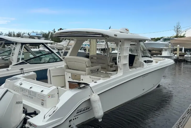  Yacht Photos Pics 2022 Boston Whaler 350 Realm boat docked at marina, side view.