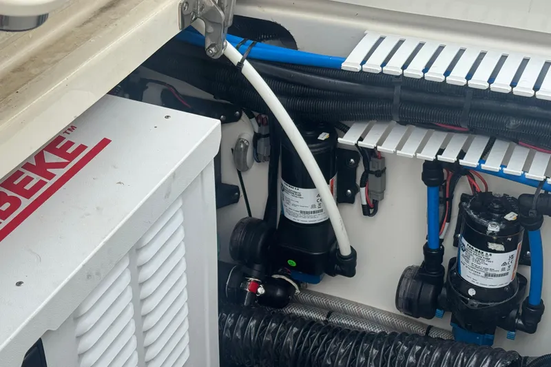  Yacht Photos Pics Engine compartment of a 2022 Boston Whaler 350 Realm, showcasing mechanical components and wiring.