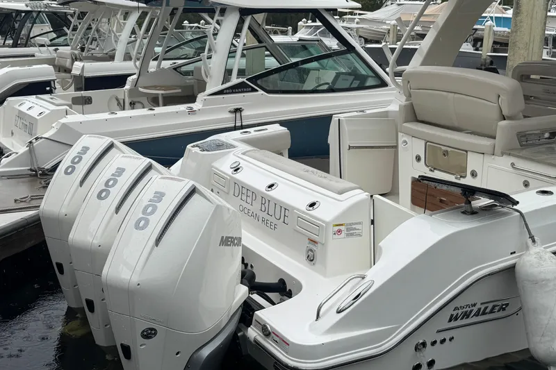  Yacht Photos Pics 2022 Boston Whaler 350 Realm boat docked with triple Mercury engines.