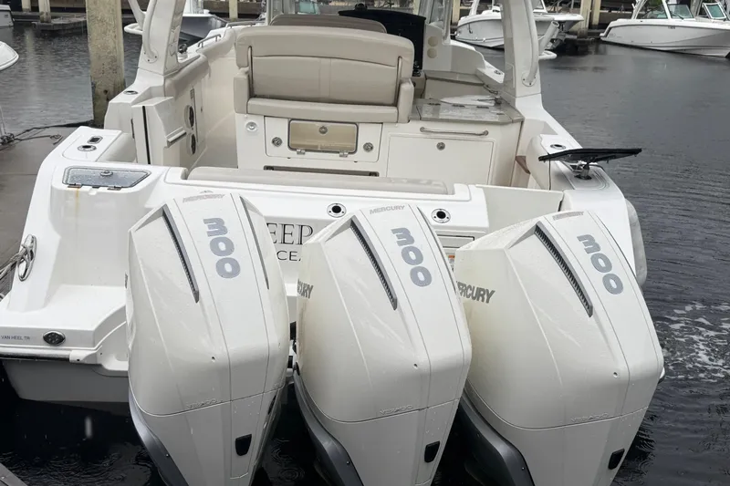  Yacht Photos Pics 2022 Boston Whaler 350 Realm with triple Mercury 300 engines docked at marina.