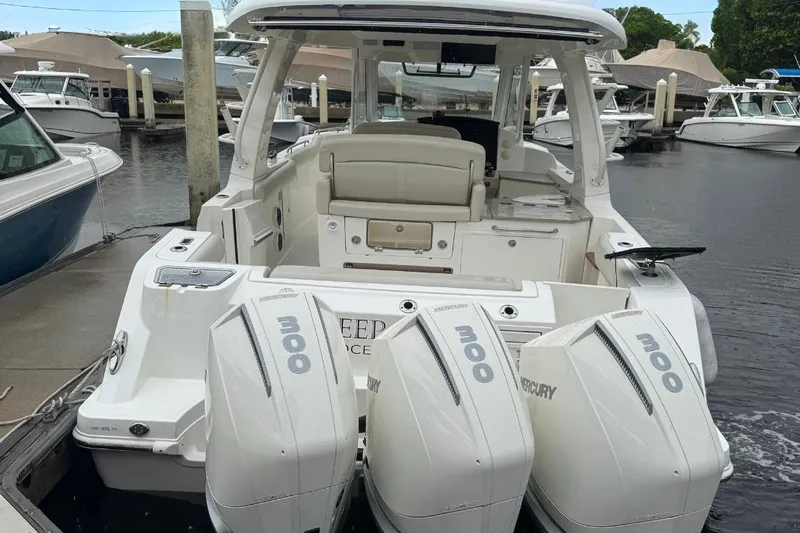  Yacht Photos Pics 2022 Boston Whaler 350 Realm with triple Mercury 300 engines docked at marina.