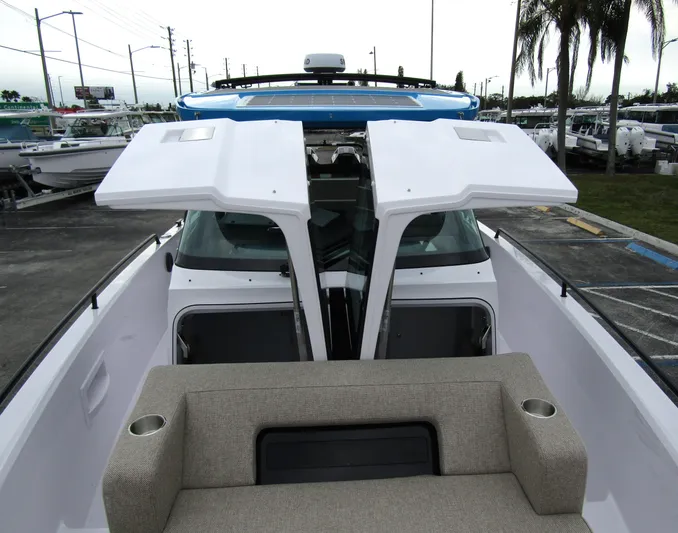  Yacht Photos Pics 2024 Axopar 37 Sun Top boat with open deck and seating area.