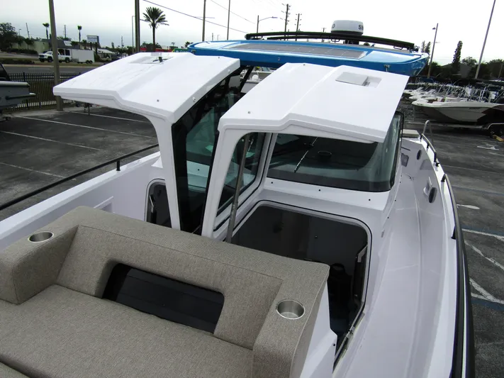  Yacht Photos Pics 2024 Axopar 37 Sun Top boat with open roof and seating area.