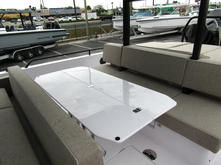 Yacht Photos Pics 2024 Axopar 37 Sun Top boat interior with seating and table.