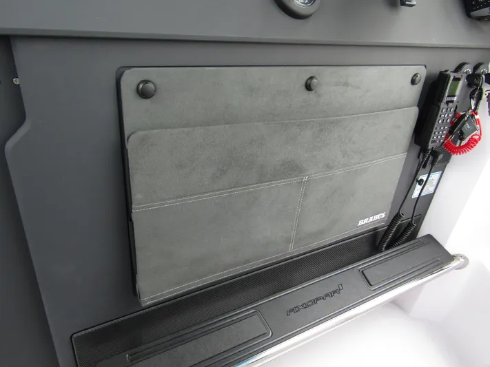  Yacht Photos Pics 2024 Axopar 37 Sun Top dashboard with storage compartment and communication equipment.