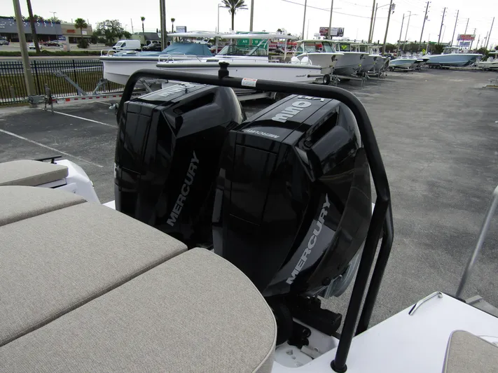  Yacht Photos Pics 2024 Axopar 37 Sun Top with dual Mercury outboard engines in a marina setting.