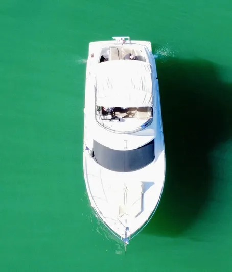  Yacht Photos Pics Aerial view of a 2014 Carver C40 yacht on green water.