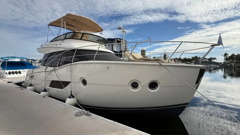  Yacht Photos Pics 2014 Carver C40 yacht docked in harbor under sunny skies.