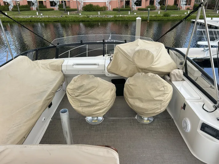  Yacht Photos Pics Carver C40 2014 yacht with covered seating area by the water.