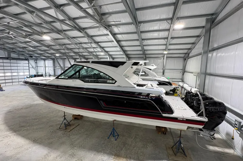  Yacht Photos Pics 2023 Formula 400 Super Sport Crossover boat in a spacious indoor storage facility.