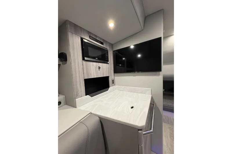  Yacht Photos Pics 2023 Formula 400 Super Sport Crossover interior with modern kitchenette and flat-screen TV.