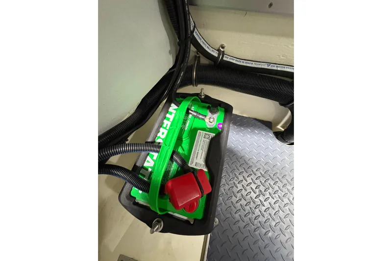  Yacht Photos Pics Battery compartment in 2023 Formula 400 Super Sport Crossover boat, featuring green battery and wiring.