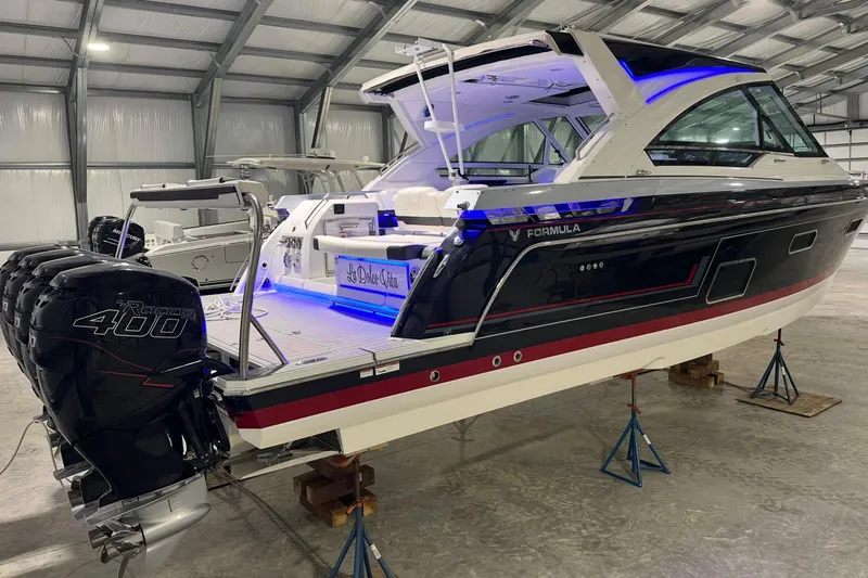  Yacht Photos Pics 2023 Formula 400 Super Sport Crossover boat in a warehouse, featuring powerful outboard engines.