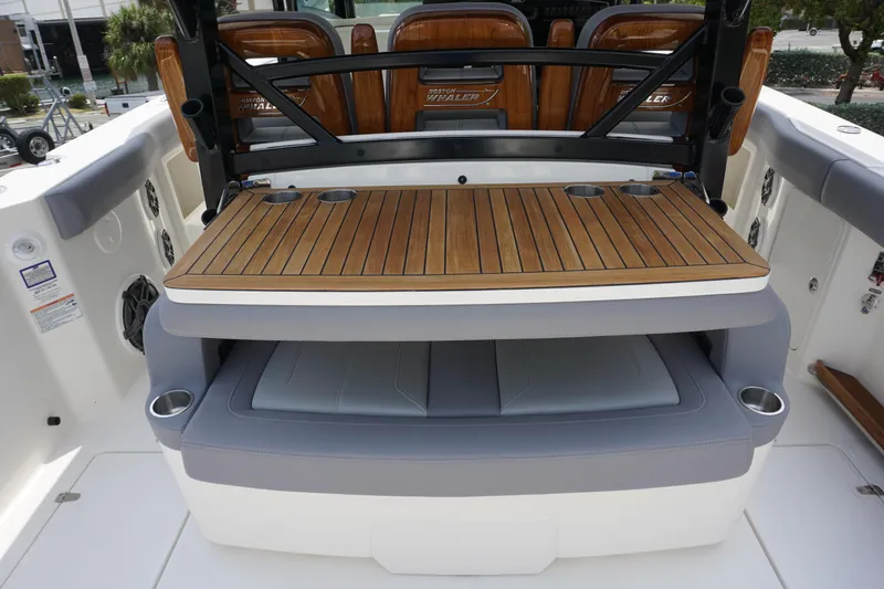 Bwcp0430a424 Yacht Photos Pics Boston Whaler 380 Outrage 2024 model, featuring a luxurious teak deck and cushioned seating.