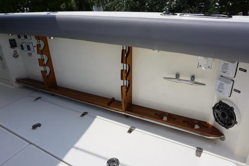 Bwcp0430a424 Yacht Photos Pics 2024 Boston Whaler 380 Outrage rod storage compartment with wooden holders and speaker.