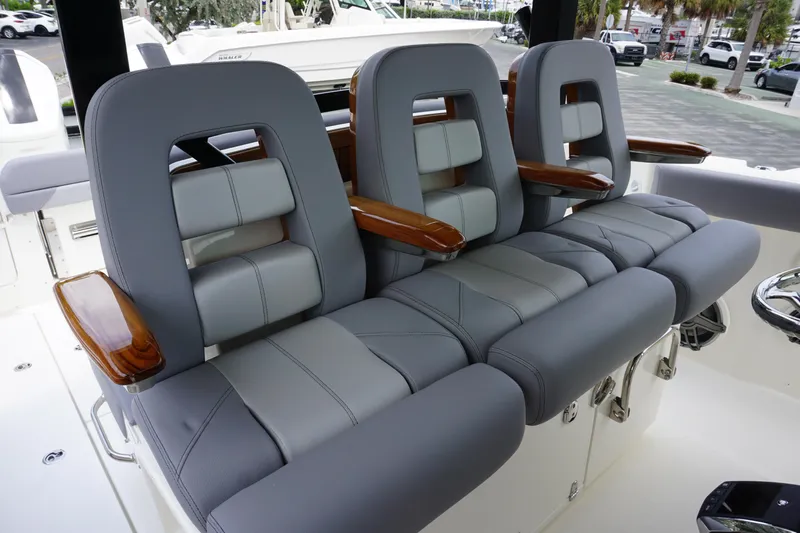 Bwcp0430a424 Yacht Photos Pics 2024 Boston Whaler 380 Outrage boat seating with gray upholstery and wooden armrests.