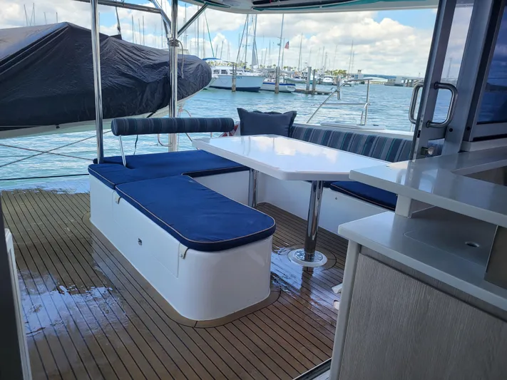  Yacht Photos Pics Leopard 44 yacht deck with seating and table, docked at marina, 2016 model.