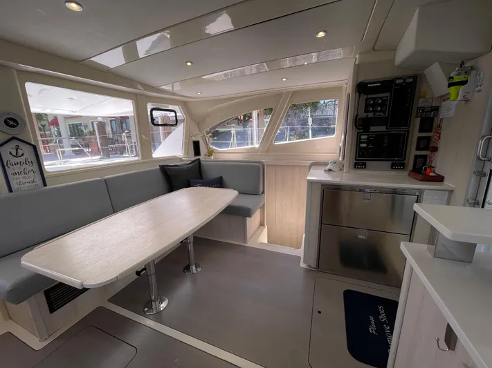 Ohana Yacht Photos Pics Interior of a 2016 Leopard 44 yacht with modern kitchen and dining area.
