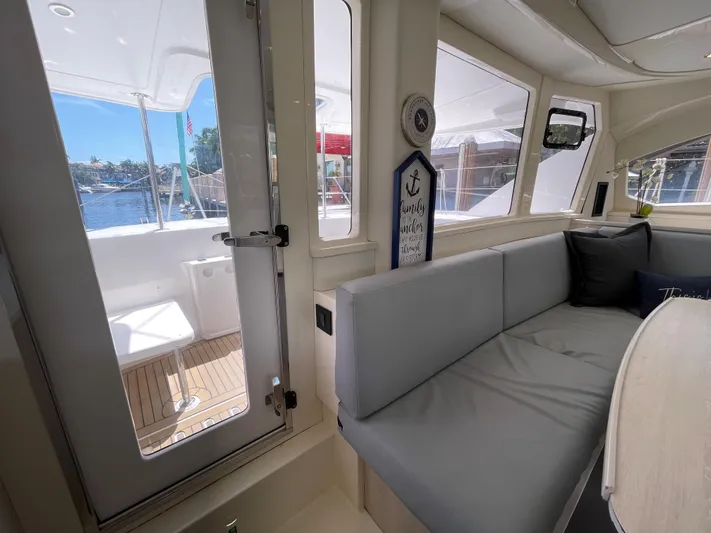 Ohana Yacht Photos Pics Interior of a 2016 Leopard 44 yacht with gray sofa.