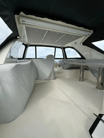  Yacht Photos Pics Interior of a 2016 Absolute 58 yacht, featuring covered seating and sleek design.