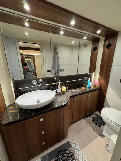  Yacht Photos Pics Luxurious bathroom in 2016 Absolute 58 yacht with modern fixtures and elegant wood cabinetry.