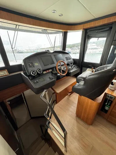  Yacht Photos Pics Interior helm of 2016 Absolute 58 yacht with modern controls and leather seating.
