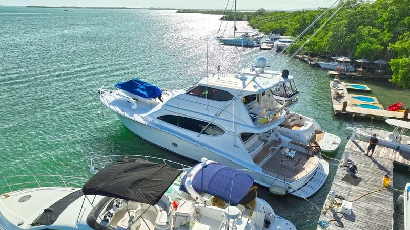  Yacht Photos Pics 2007 Hatteras 68 Convertible yacht docked in a scenic marina setting.