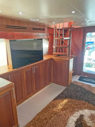  Yacht Photos Pics Interior of 2007 Hatteras 68 Convertible yacht with wooden cabinetry and spiral staircase.