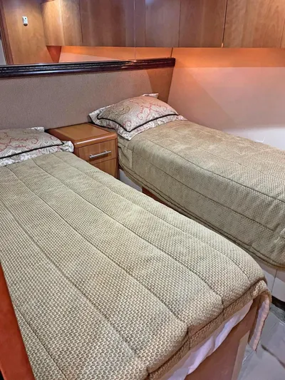  Yacht Photos Pics 2007 Hatteras 68 Convertible cabin with twin beds and wooden cabinetry.