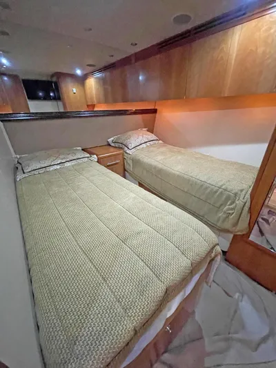  Yacht Photos Pics 2007 Hatteras 68 Convertible yacht cabin with twin beds and wooden interior.