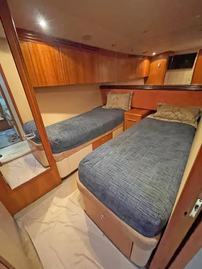  Yacht Photos Pics 2007 Hatteras 68 Convertible cabin with twin beds and wooden cabinetry.