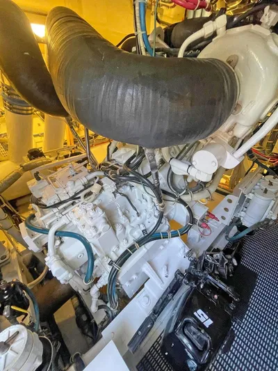  Yacht Photos Pics Engine room of a 2007 Hatteras 68 Convertible yacht, showcasing complex machinery and components.