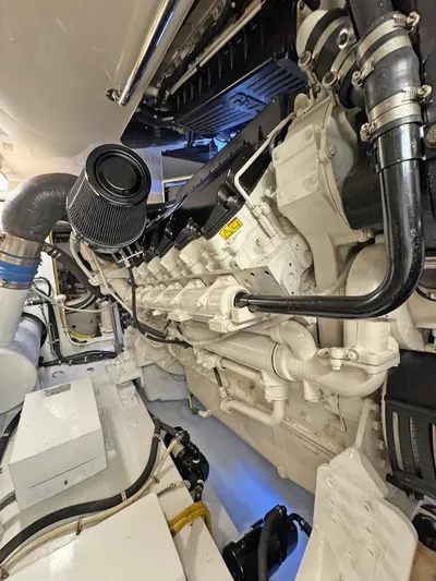  Yacht Photos Pics Engine room of 2007 Hatteras 68 Convertible yacht, showcasing detailed machinery and components.