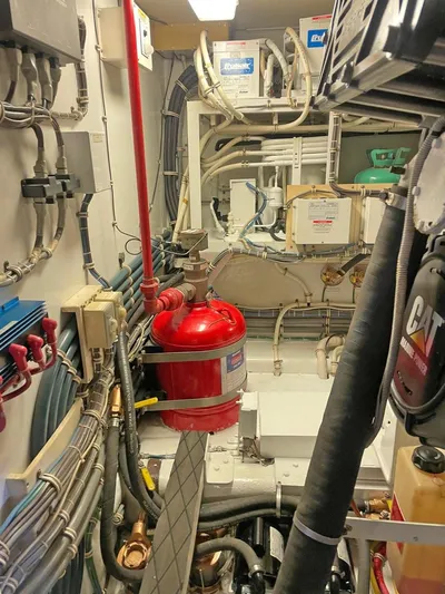  Yacht Photos Pics Engine room of a 2007 Hatteras 68 Convertible yacht, showcasing complex wiring and machinery.