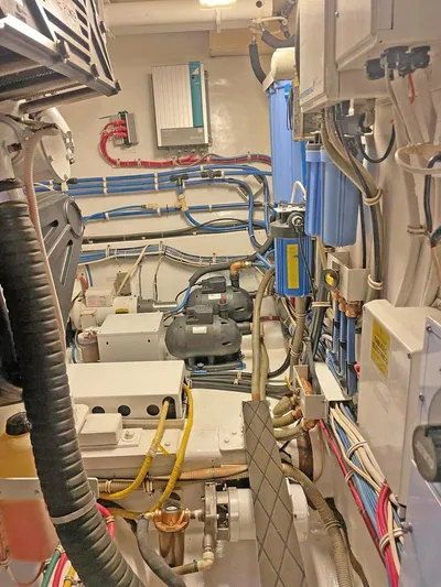  Yacht Photos Pics Engine room of 2007 Hatteras 68 Convertible yacht, showcasing complex machinery and wiring.