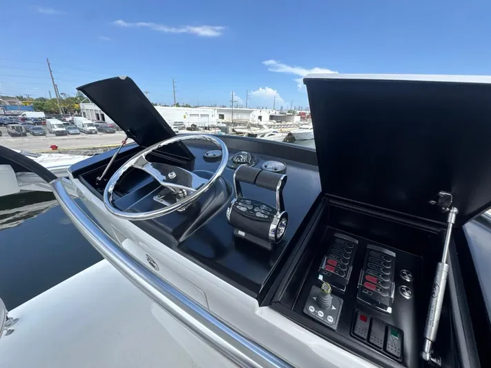 Dry Bones Yacht Photos Pics Control panel of a 2017 Viking 66 Enclosed Bridge yacht with steering wheel and controls.