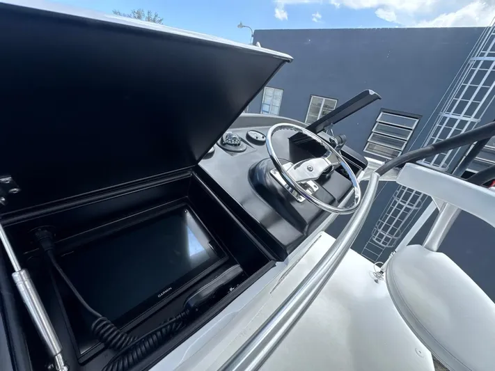 Dry Bones Yacht Photos Pics 2017 Viking 66 Enclosed Bridge helm with steering wheel and navigation display.