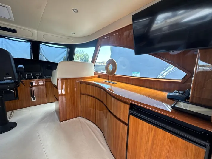 Dry Bones Yacht Photos Pics Luxurious interior of 2017 Viking 66 Enclosed Bridge yacht with wood finish and modern amenities.
