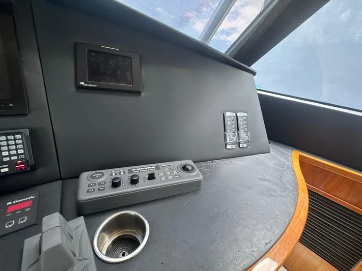 Dry Bones Yacht Photos Pics Control panel of 2017 Viking 66 Enclosed Bridge yacht, featuring navigation and electronic systems.