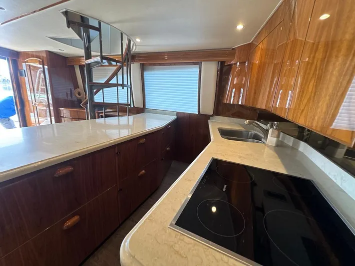 Dry Bones Yacht Photos Pics Luxurious kitchen interior of 2017 Viking 66 Enclosed Bridge yacht with modern appliances.