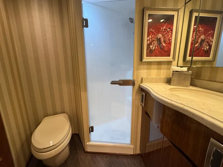 Dry Bones Yacht Photos Pics Luxurious bathroom in 2017 Viking 66 Enclosed Bridge yacht with modern fixtures and elegant decor.