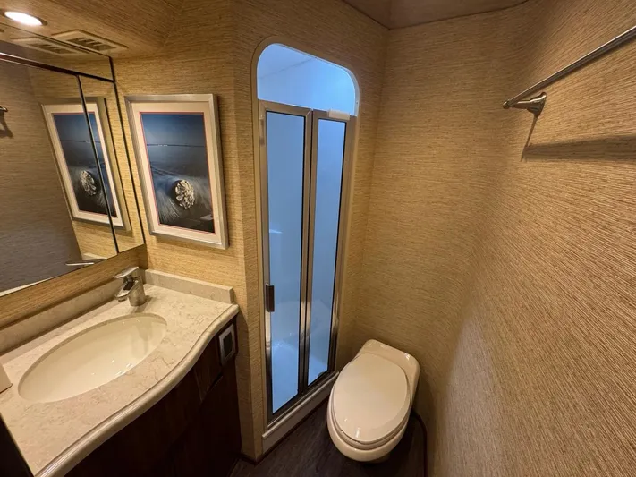 Dry Bones Yacht Photos Pics Luxurious bathroom in 2017 Viking 66 Enclosed Bridge yacht with modern fixtures and elegant decor.