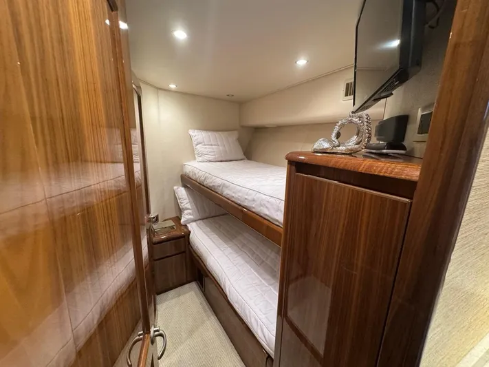 Dry Bones Yacht Photos Pics 2017 Viking 66 Enclosed Bridge cabin with bunk beds and wooden cabinetry.