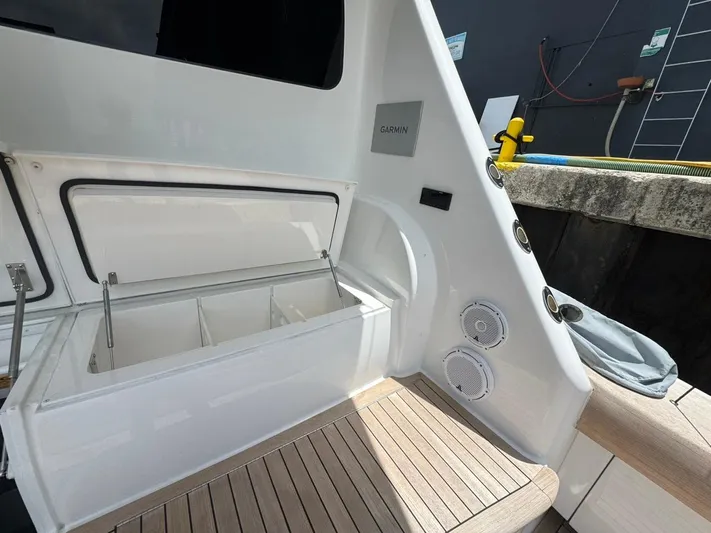 Dry Bones Yacht Photos Pics 2017 Viking 66 Enclosed Bridge yacht with open storage compartment and speakers on deck.