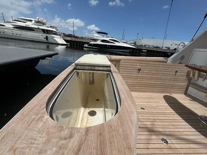 Dry Bones Yacht Photos Pics 2017 Viking 66 Enclosed Bridge yacht deck with open storage compartment, docked at marina.